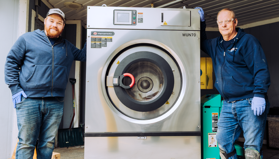 two men next to industrial washer