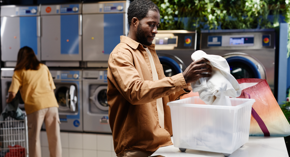 man sorting laundry at coin laundry mat